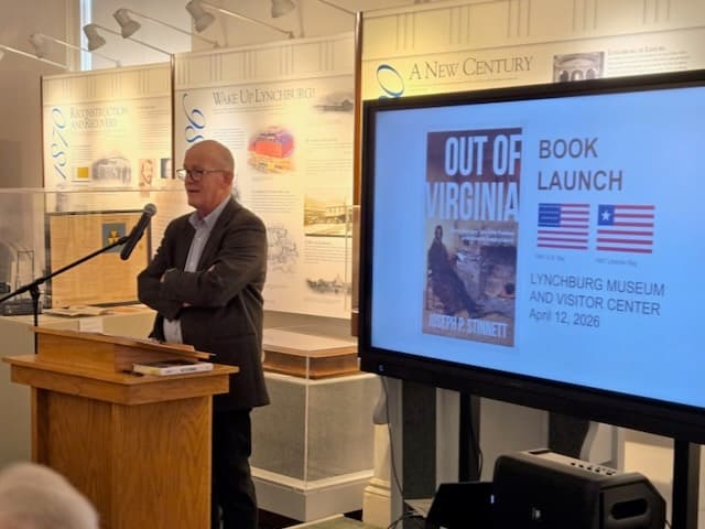 Joe Stinnett speaking at the podium during the Out of Virginia book launch
